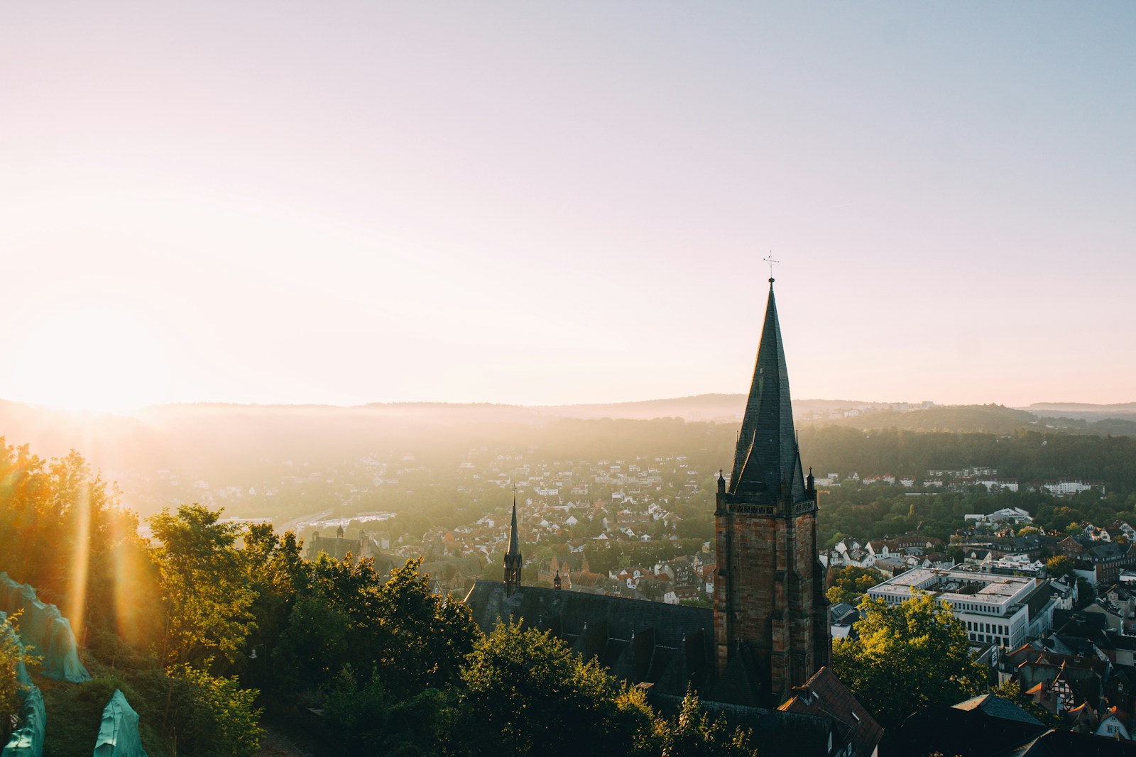 a view of a city with a steeple in the background